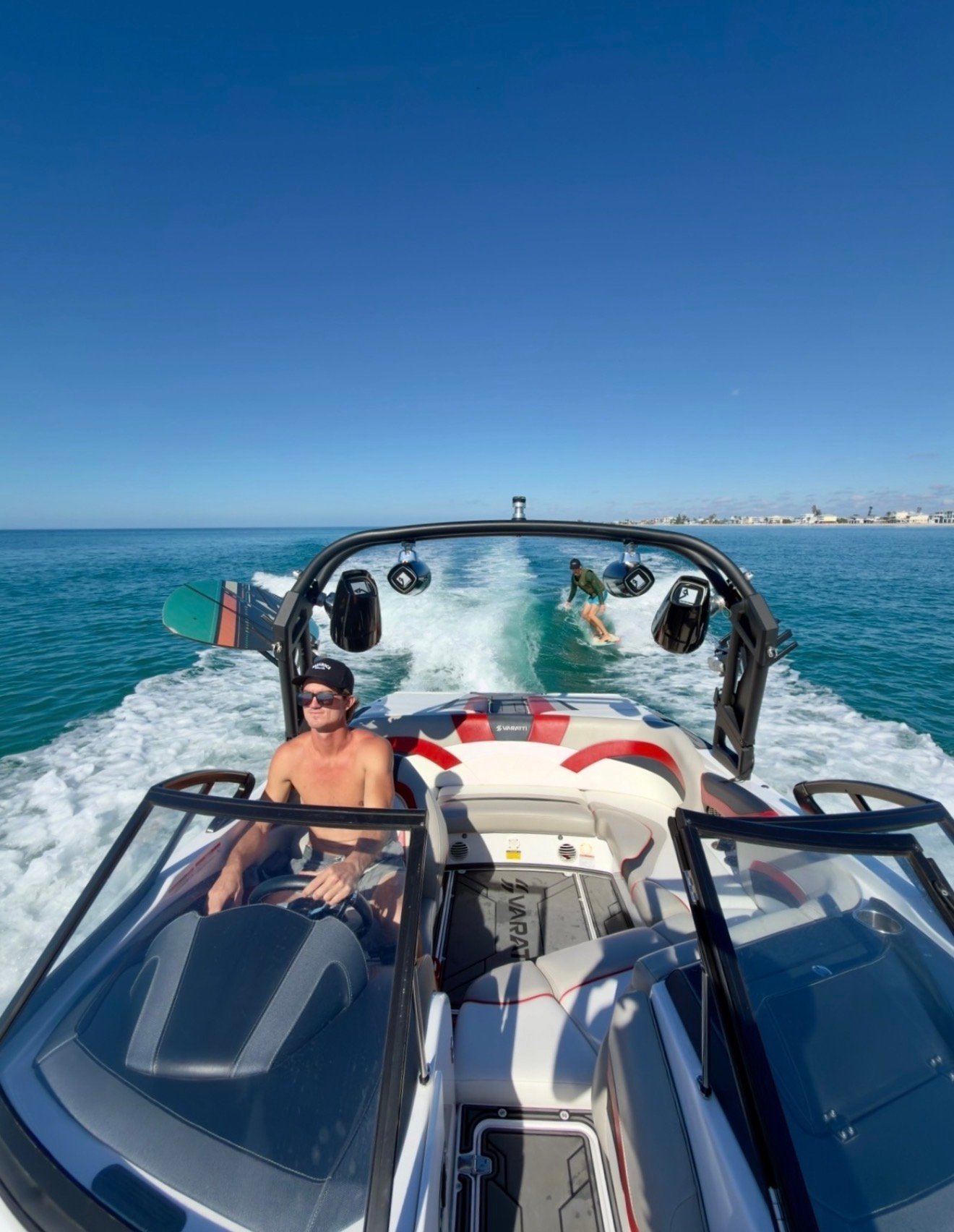 Captain ET driving with surfer in the wake